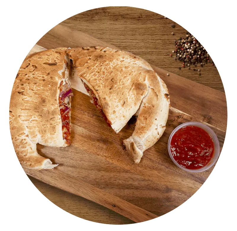 Panzerotti stuffed with cheese and toppings at Queen's Pizza & Wings in Hamilton, ON